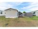 Exterior side view of the home with shed at 5428 Joyce St, Zephyrhills, FL 33542