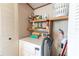 The laundry area has a dryer with shelving above for storage and supplies at 5428 Joyce St, Zephyrhills, FL 33542