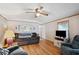Cozy living room with hardwood floors, comfortable seating, and ample natural light at 5428 Joyce St, Zephyrhills, FL 33542