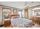 Well-lit main bedroom has two windows, closet and attached bathroom at 5428 Joyce St, Zephyrhills, FL 33542