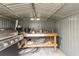 The shed has a metal interior, a workbench, and a grill at 5428 Joyce St, Zephyrhills, FL 33542