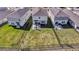 Aerial view of a backyard with an outdoor seating area, lawn, and black metal fence at 5486 Summer Sunset Dr, Apollo Beach, FL 33572