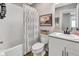 Cozy bathroom featuring a tub with shower, toilet, vanity, and framed flamingo art at 5486 Summer Sunset Dr, Apollo Beach, FL 33572