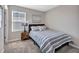 Bedroom featuring a striped bedspread, side table, and a view of the window at 5486 Summer Sunset Dr, Apollo Beach, FL 33572