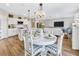 Cozy dining area connected to the kitchen and living room with stylish decor and natural lighting at 5486 Summer Sunset Dr, Apollo Beach, FL 33572