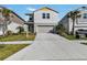 Charming two-story home featuring a well-manicured lawn, two car garage, and inviting light blue front door at 5486 Summer Sunset Dr, Apollo Beach, FL 33572