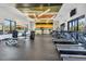 Bright community gym with treadmills, exercise bikes, weights, and a vibrant striped accent wall at 5486 Summer Sunset Dr, Apollo Beach, FL 33572