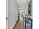 Inviting hallway with stylish decor, wood floors, and a view into a naturally lit living room at 5486 Summer Sunset Dr, Apollo Beach, FL 33572