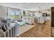 Open floor plan with hardwood floors connecting the living room, dining area, and kitchen at 5486 Summer Sunset Dr, Apollo Beach, FL 33572