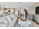 Open-concept living room features hardwood floors, stairs, neutral tones, and modern decor at 5486 Summer Sunset Dr, Apollo Beach, FL 33572