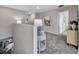 Upstairs hallway with neutral carpet leading to bedroom doors at 5486 Summer Sunset Dr, Apollo Beach, FL 33572