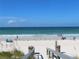 A calming ocean view with people enjoying the beach under a blue sky at 5561 24Th N Ter, St Petersburg, FL 33710