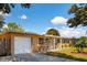 Charming single-story home featuring a well-manicured lawn, a white picket fence and a single-car garage at 5561 24Th N Ter, St Petersburg, FL 33710