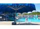 Community pool with blue shade umbrella at 5561 24Th N Ter, St Petersburg, FL 33710
