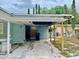 Exterior shot of the side of the house with a carport and overgrown lawn at 5720 21St W St, Bradenton, FL 34207
