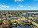 Scenic aerial perspective of a waterfront community featuring canals, private docks, and lush landscaping at 6104 Schooner Way, Tampa, FL 33615
