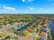 Aesthetic aerial photograph of a waterfront neighborhood with private docks, canals, and verdant trees at 6104 Schooner Way, Tampa, FL 33615