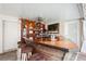 This unique outdoor bar has a wooden countertop with three stools, shelves and decor on the paneled wall at 6104 Schooner Way, Tampa, FL 33615