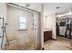 Custom bathroom with tiled shower, granite seat, walk-in closet, and adjacent vanity area at 6104 Schooner Way, Tampa, FL 33615
