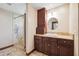 Bathroom with custom cabinet and granite countertop, and separate shower with stone surround at 6104 Schooner Way, Tampa, FL 33615