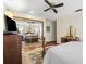 Bedroom with hardwood floors, ceiling fan, and mirrored closet doors that reflects the room at 6104 Schooner Way, Tampa, FL 33615