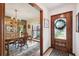 Elegant dining room adjacent to front door with hardwood table set and natural lighting at 6104 Schooner Way, Tampa, FL 33615