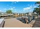 Dock view, showcasing boat lifts and scenic waterfront views with houses across the canal at 6104 Schooner Way, Tampa, FL 33615