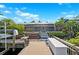Wooden dock with a boat lift overlooking the water, screened lanai and landscaped backyard at 6104 Schooner Way, Tampa, FL 33615