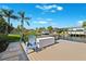 Waterfront view from the dock, with a cozy chair, and lush landscaping providing a serene retreat at 6104 Schooner Way, Tampa, FL 33615