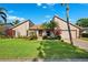 Inviting home featuring a manicured lawn, mature landscaping, and a welcoming entrance at 6104 Schooner Way, Tampa, FL 33615