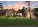 Charming home with beautifully landscaped front yard and an inviting entrance at sunset at 6104 Schooner Way, Tampa, FL 33615
