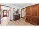 Hallway featuring tile flooring, classic wood furnishings, and decorative wall art at 6104 Schooner Way, Tampa, FL 33615