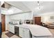 Bright kitchen features white cabinets and appliances, with large countertops at 6104 Schooner Way, Tampa, FL 33615