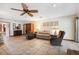 Open living room with ceiling fan, tile floors, and comfortable seating at 6104 Schooner Way, Tampa, FL 33615