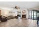Open living room with fireplace, ceiling fan, and sliding doors at 6104 Schooner Way, Tampa, FL 33615