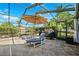 Enjoy this covered outdoor patio with a seating area, perfect for relaxing and enjoying the outdoor scenery at 6104 Schooner Way, Tampa, FL 33615