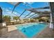 The backyard features a refreshing pool with an enclosed patio, perfect for enjoying outdoor living at 6104 Schooner Way, Tampa, FL 33615