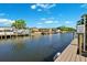 Scenic canal view from the dock, lined with well-maintained homes and boat docks under a clear sky at 6104 Schooner Way, Tampa, FL 33615