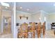 Elegant bar area features granite counters, wooden barstools, and display shelves for a stylish entertaining space at 6201 Marbella Blvd, Apollo Beach, FL 33572