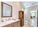 Well-lit bathroom with vanity, wood cabinet, and marble countertop at 6201 Marbella Blvd, Apollo Beach, FL 33572