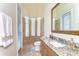 Bathroom with large mirror, tiled floor, glass-walled shower, and large windows providing natural light at 6201 Marbella Blvd, Apollo Beach, FL 33572