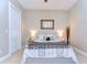 Inviting bedroom offers a comfortable bed, soft lighting, and a mirror for a relaxing ambiance at 6201 Marbella Blvd, Apollo Beach, FL 33572