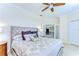Comfortable bedroom showcasing a decorative ceiling fan, plush bedding, and a serene ambiance at 6201 Marbella Blvd, Apollo Beach, FL 33572