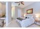 Tranquil bedroom features a cozy bed, a decorative mirror, and soft lighting for a peaceful retreat at 6201 Marbella Blvd, Apollo Beach, FL 33572