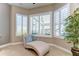 Bedroom nook featuring plantation shutters and cushioned chaise lounge for relaxation at 6201 Marbella Blvd, Apollo Beach, FL 33572