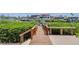 Wooden dock leading to waterfront with lush greenery and picturesque views at 6201 Marbella Blvd, Apollo Beach, FL 33572
