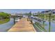 Private boat dock featuring lift, seating, and waterfront views at 6201 Marbella Blvd, Apollo Beach, FL 33572