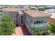 Mediterranean style home with red tile roof, prominent columns, and a brick driveway at 6201 Marbella Blvd, Apollo Beach, FL 33572