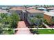 Stunning waterfront home featuring a brick driveway and lush tropical landscaping at 6201 Marbella Blvd, Apollo Beach, FL 33572