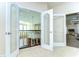 Hallway with glass french doors, leading to multiple rooms, providing an open and inviting feel at 6201 Marbella Blvd, Apollo Beach, FL 33572